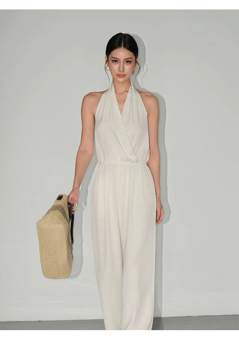 Minimalist draped halter wide-leg jumpsuit with elastic waist and relaxed full-length silhouette