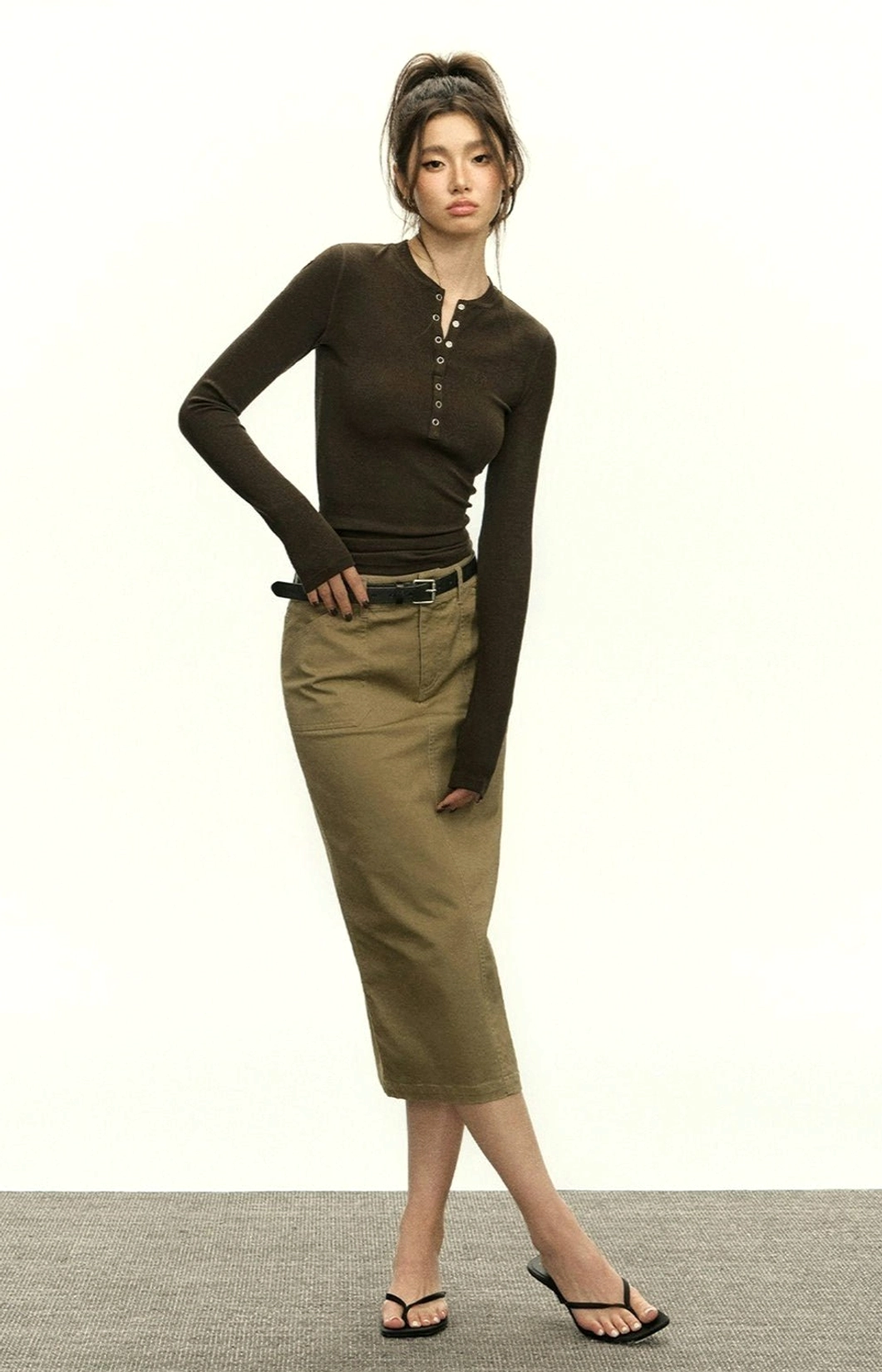 Minimalist ribbed Henley crop top for layering with denim, wide-leg trousers, and contemporary streetwear outfits