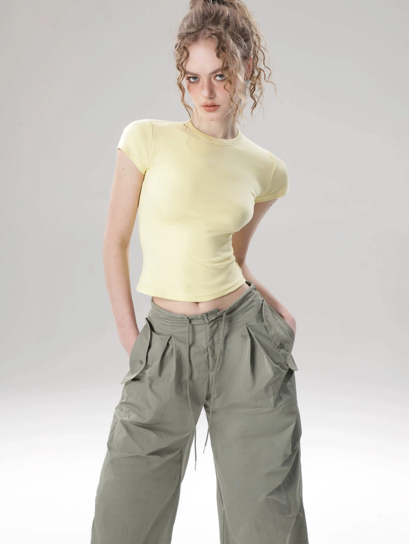 Minimalist cropped streetwear top with smooth solid color fabric and waist-defining silhouette