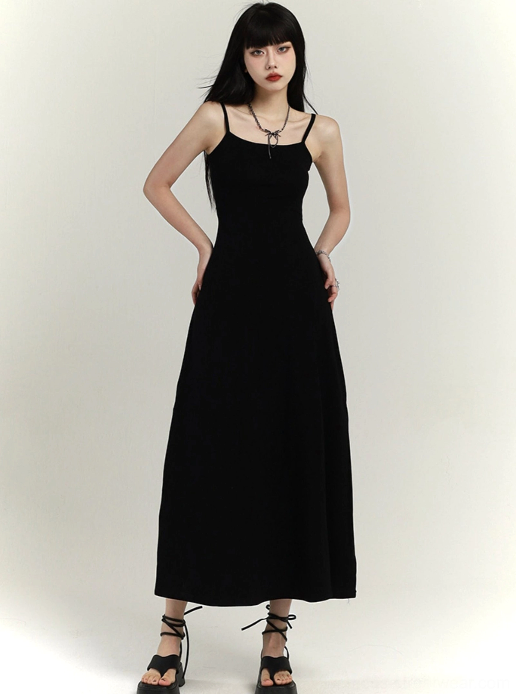 Black minimalist spaghetti strap maxi dress showing square neckline fitted bodice and flared skirt