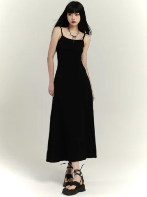 Black square neck maxi slip dress with slim waist and flared floor-length skirt front three-quarter view