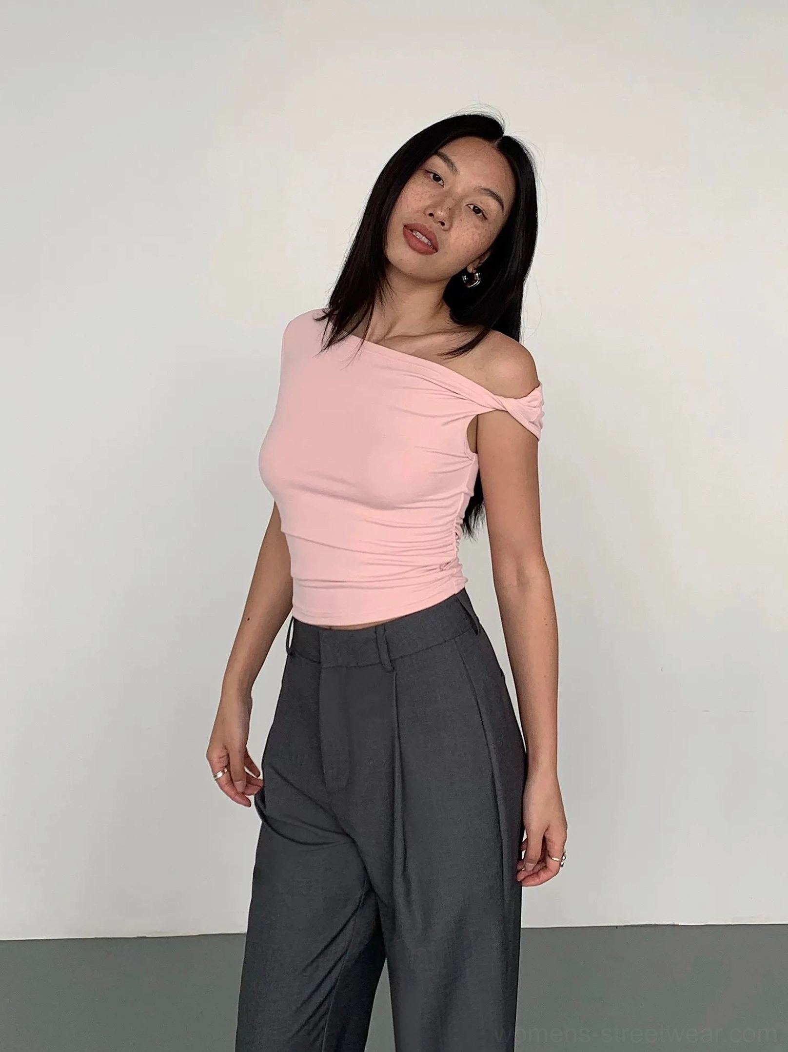 Minimalist women’s one-shoulder crop top with asymmetric sleeve styling and versatile solid-color design