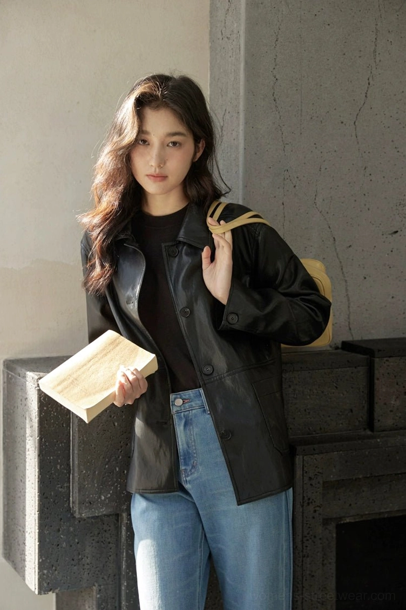 Minimalist women’s short leather jacket with clean front closure and refined streetwear attitude