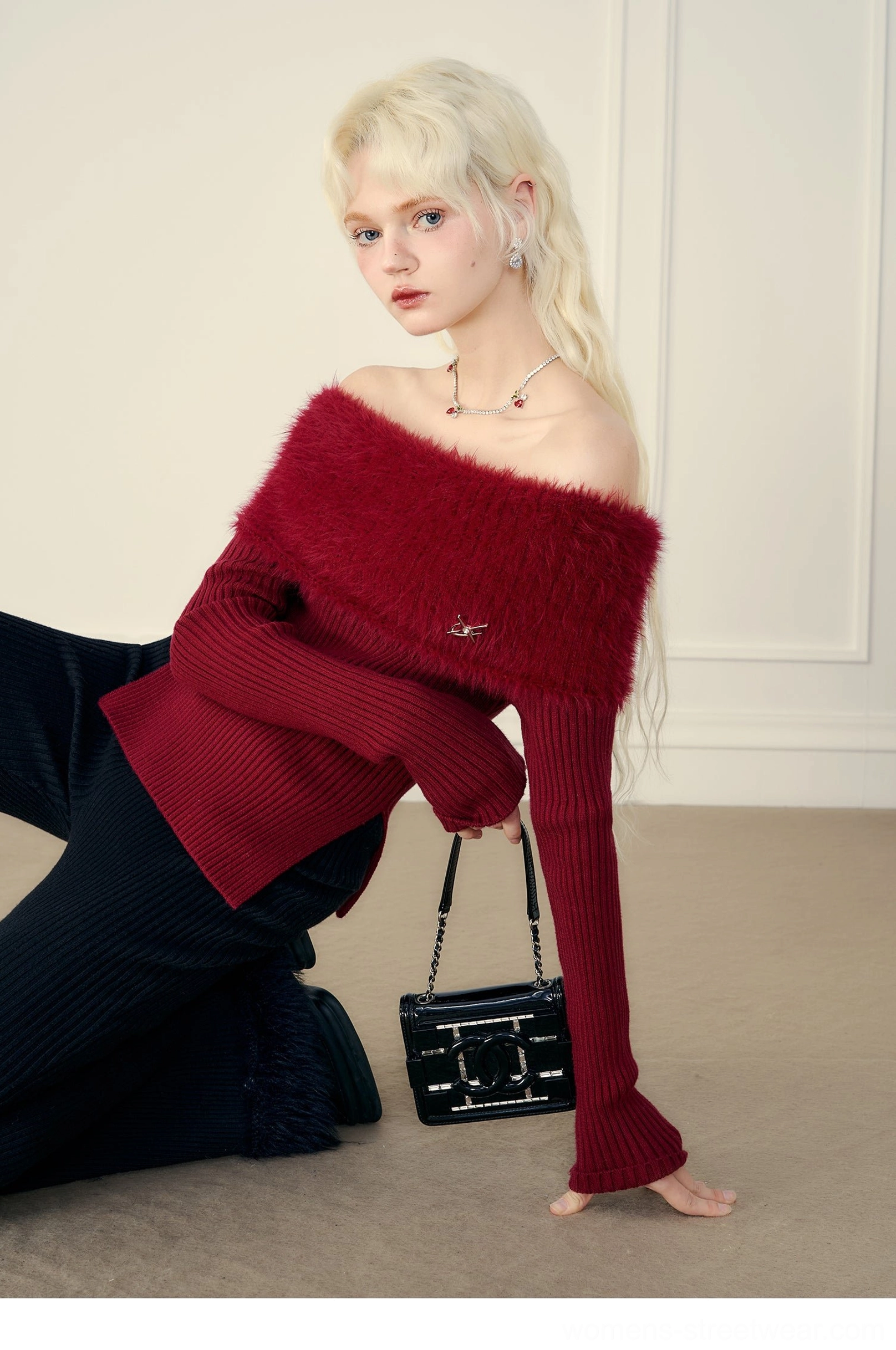 Wine red mink cashmere off-shoulder sweater showing plush neckline and fitted ribbed silhouette