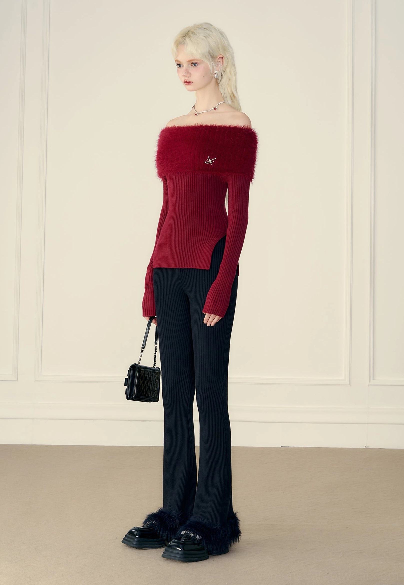 Side front view of wine red off-shoulder fur trim ribbed knit sweater with side slit hem