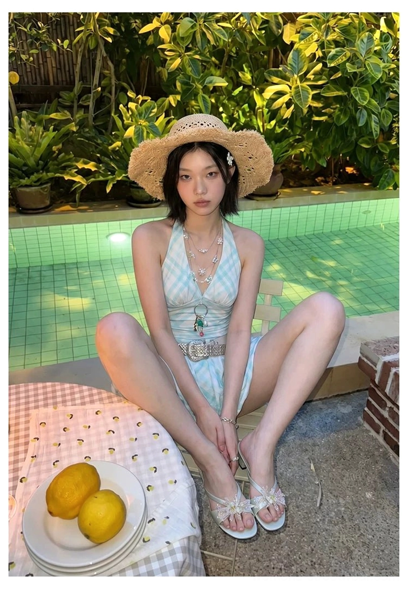 Mint floral crystal crossover block heel mules worn with a blue check swimsuit at a tropical poolside