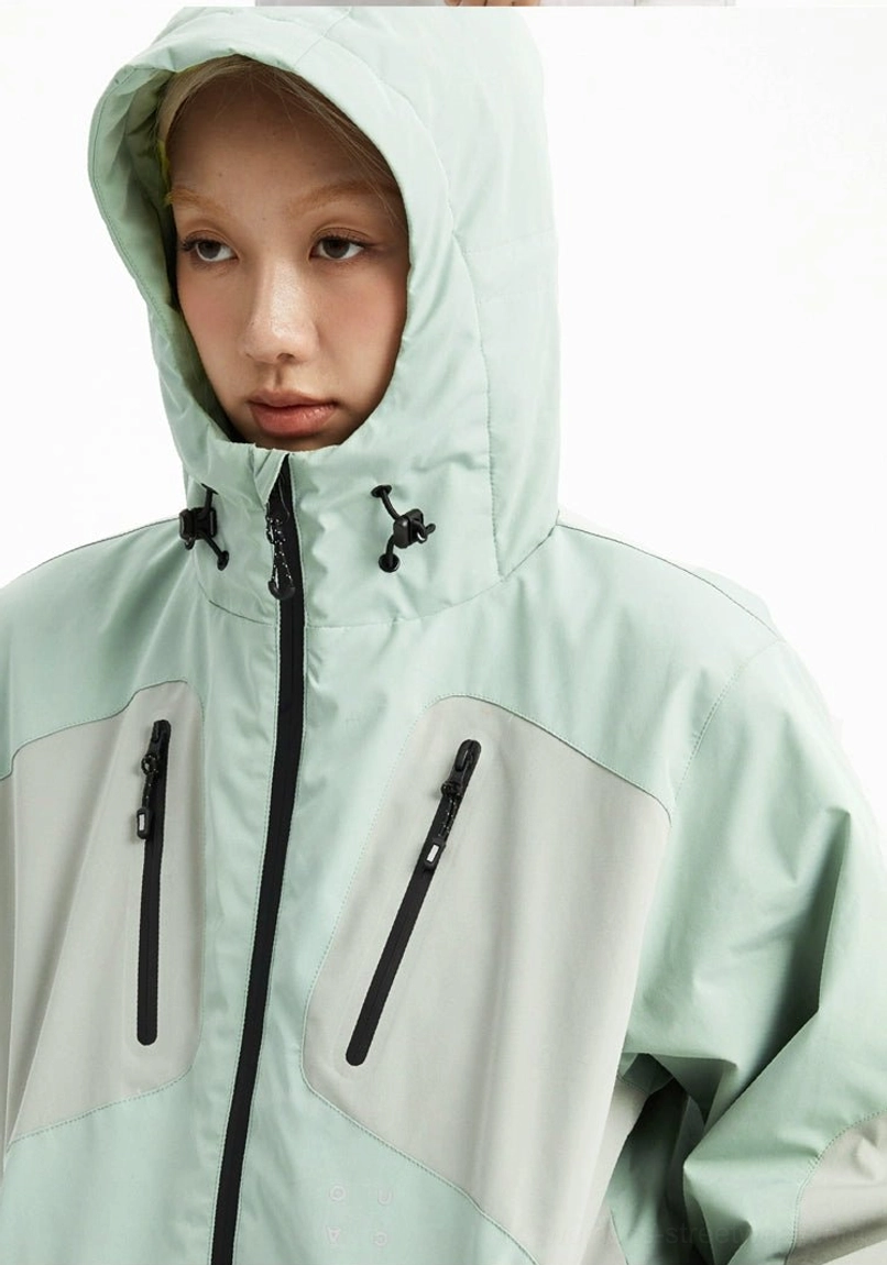 Mint green color block outdoor hooded jacket close-up with adjustable toggles, front zipper, and zippered chest pockets