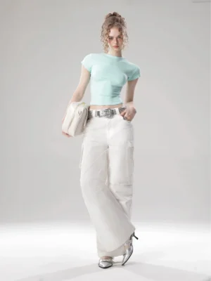 Mint green Korean streetwear cropped top styled with white wide-leg pants silver belt and beige shoulder bag