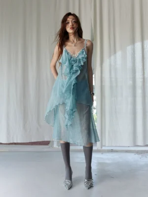 Mint green ruffle chiffon midi dress shown in a full front view with cascading ruffles, lace V-neck, grey knee-high socks, and silver pointed mules