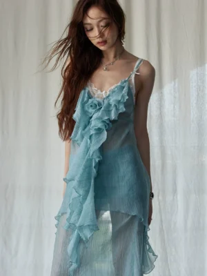 Close-up of mint green sheer chiffon midi dress featuring adjustable spaghetti straps, layered ruffle front, 3D flower detail, and lace neckline