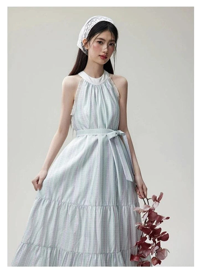 Half-body side front view of a mint and lavender check halter dress with lace neckline, tied waist sash, and floor-length tiered silhouette