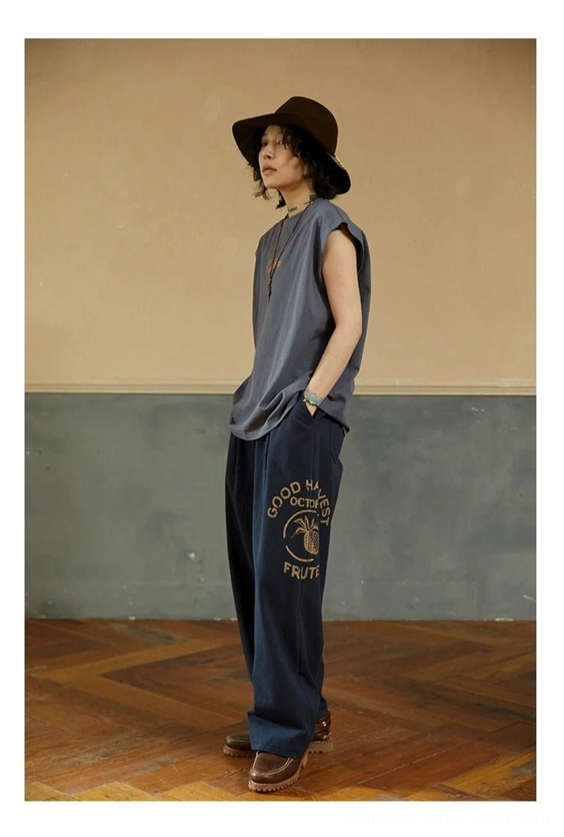 Misty Purple Blue relaxed sleeveless tee tucked into printed wide-leg denim for an artistic vintage streetwear outfit