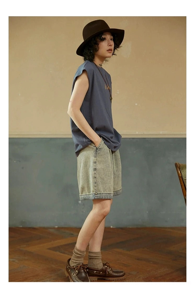 Misty Purple Blue sleeveless cotton tee side view styled with denim shorts, cowboy hat, and brown leather shoes