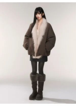 Mocha faux fur collar oversized cocoon down parka shown in a full body front view with a mini skirt, sheer tights, and brown fuzzy cuff boots