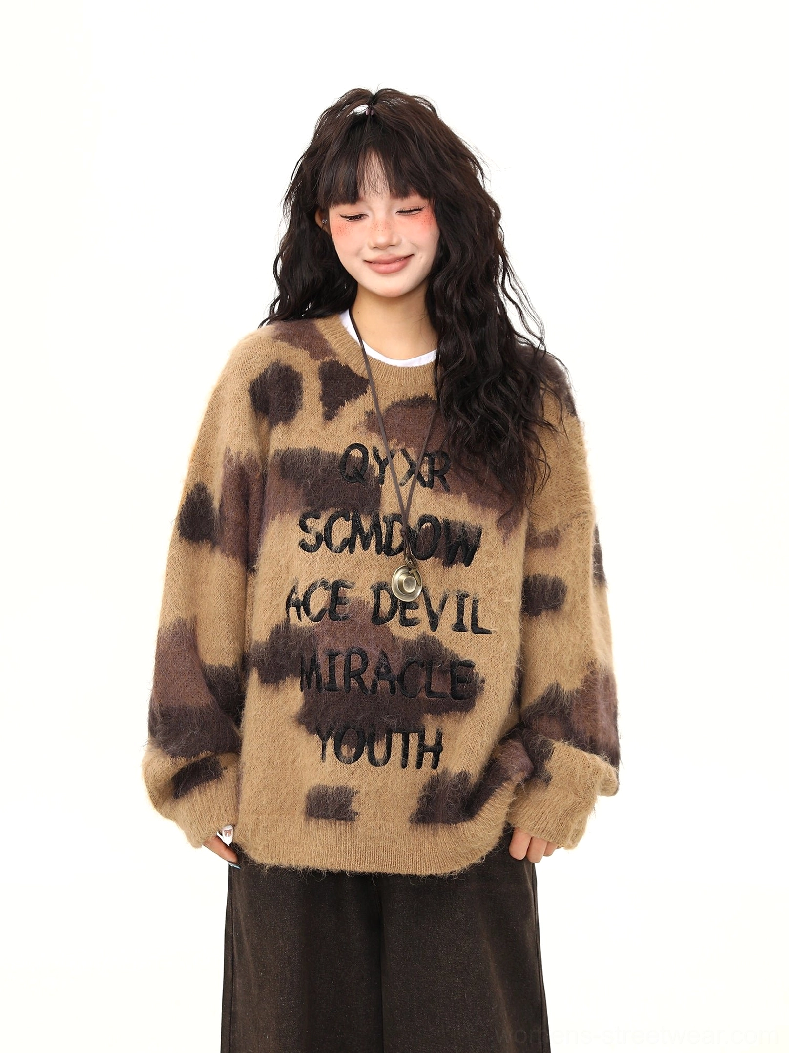 Oversized mocha brown fuzzy sweater front view with dark abstract graphics and ribbed crew neckline