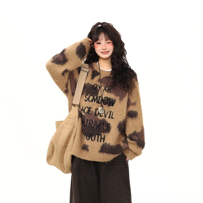 Close-up front view of brown mocha fuzzy graphic streetwear sweater with abstract leopard-style pattern