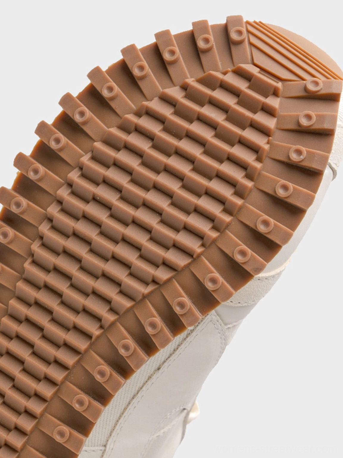 Modern cream retro runner sneakers with black toe cap, decorative stitching, lace-up design, and textured waffle rubber sole