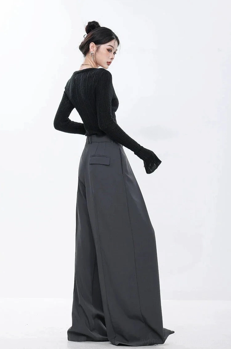 Modern dark gray pleated trousers with a high waist and exaggerated full-length streetwear silhouette