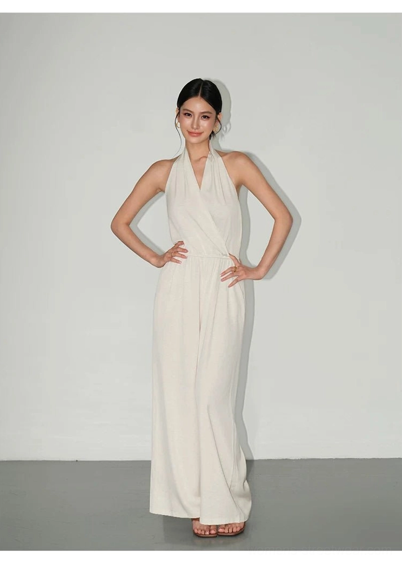 Modern halter-neck wide-leg jumpsuit featuring a softly gathered waist and lightweight textured fabric