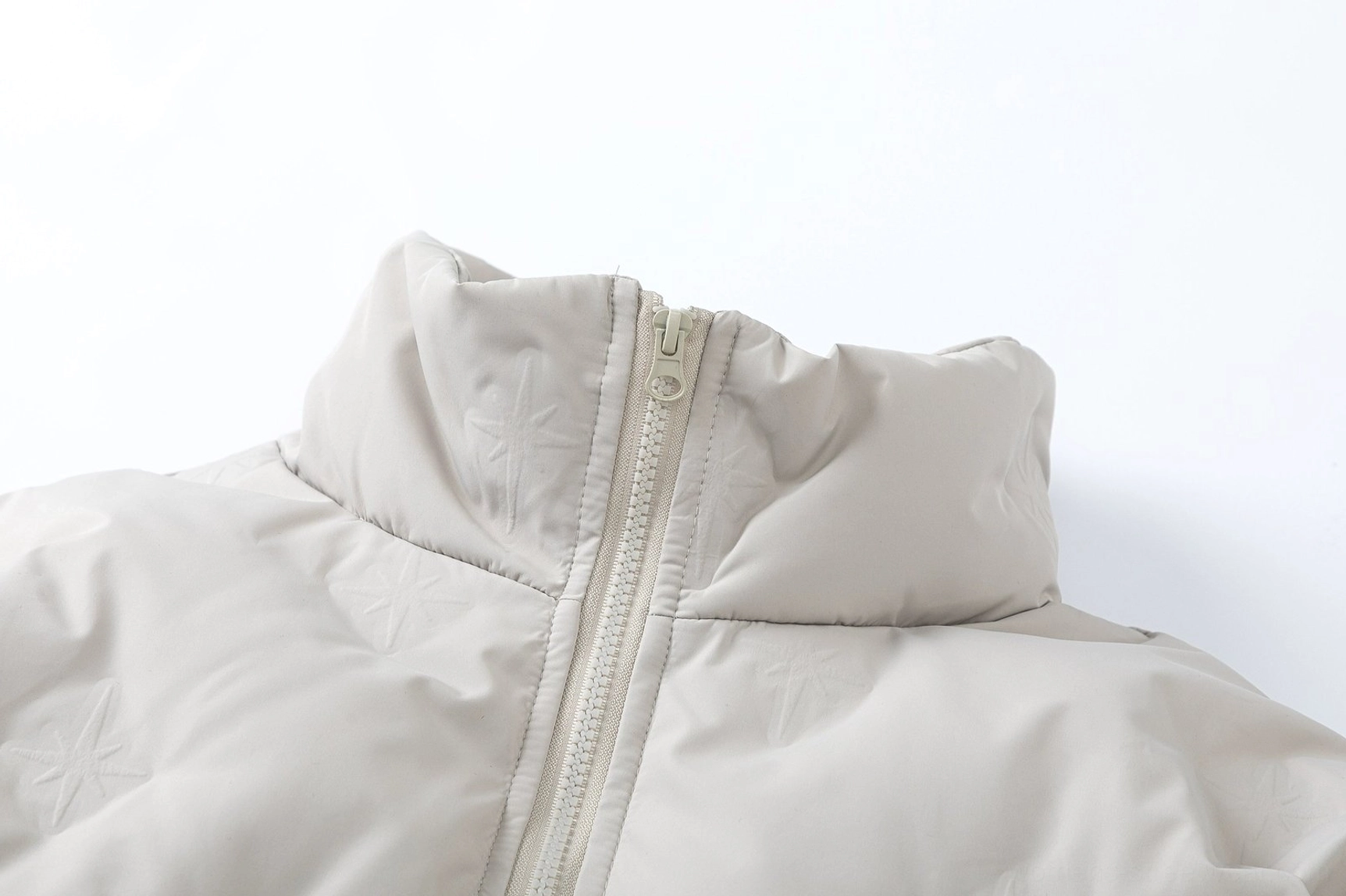 Modern oversized stand-collar bomber jacket with quilted puffer construction, hidden pockets, and adjustable hem