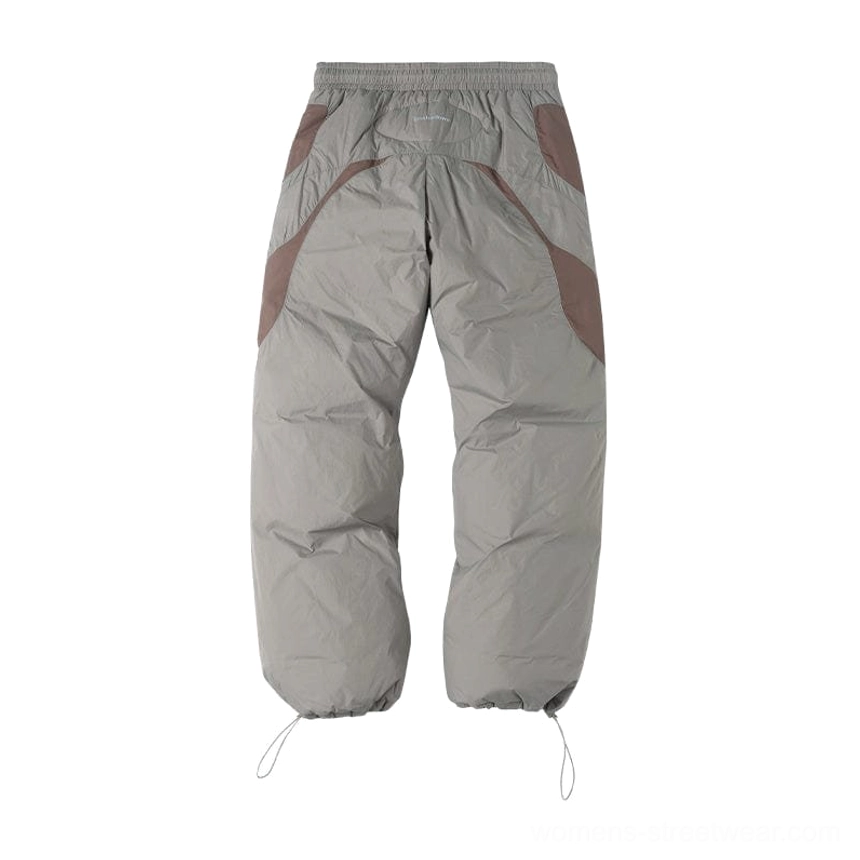 Modern padded track pants with taupe gray body dark brown panels and oversized Seoul-inspired streetwear silhouette