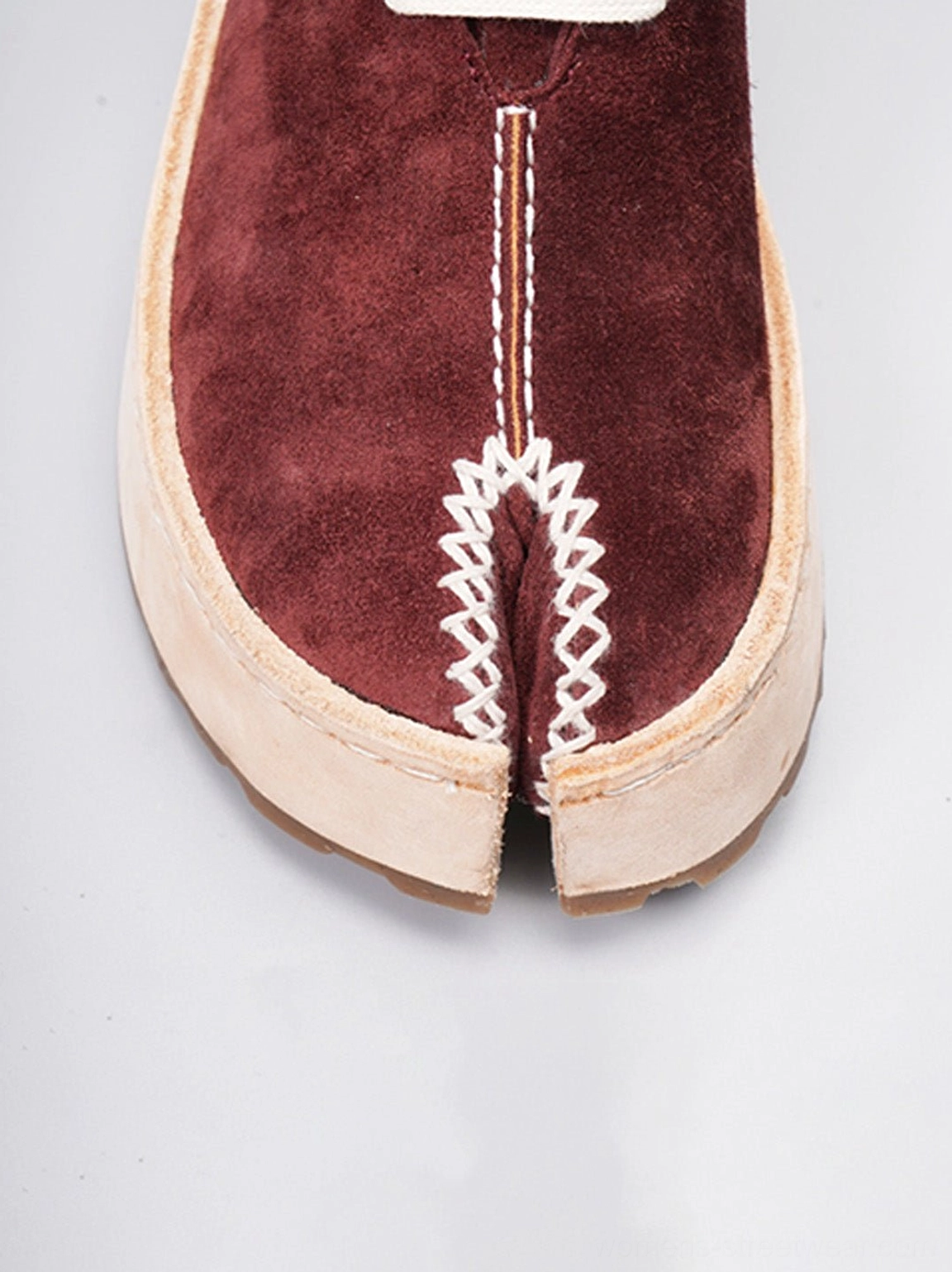 Modern split-toe leather lace-up boots with rounded front, contrast stitching, and versatile unisex streetwear design