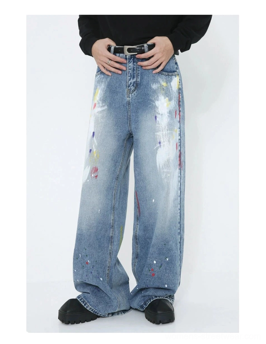 Modern streetwear wide-leg jeans in washed blue denim with expressive paint splatter graphics and an artistic graffiti finish