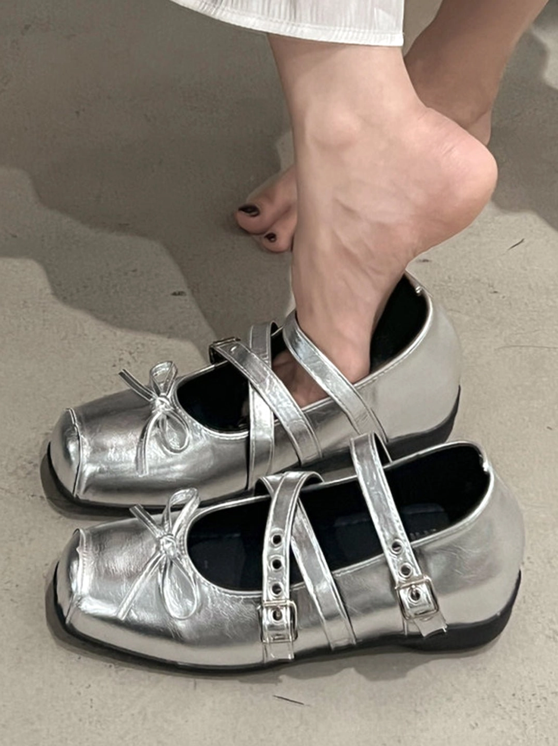 Modern women's square-toe Mary Jane flats with double straps, low flat outsole, and statement bow
