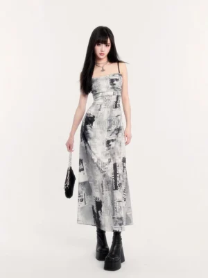 Front view of white monochrome newspaper print ruched slip maxi dress with black spaghetti straps and square neckline