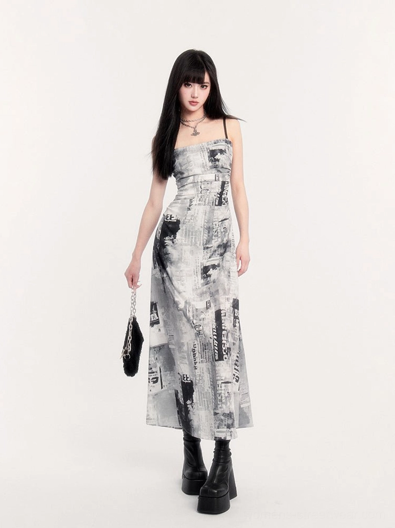 Front view of white monochrome newspaper print ruched slip maxi dress with black spaghetti straps and square neckline
