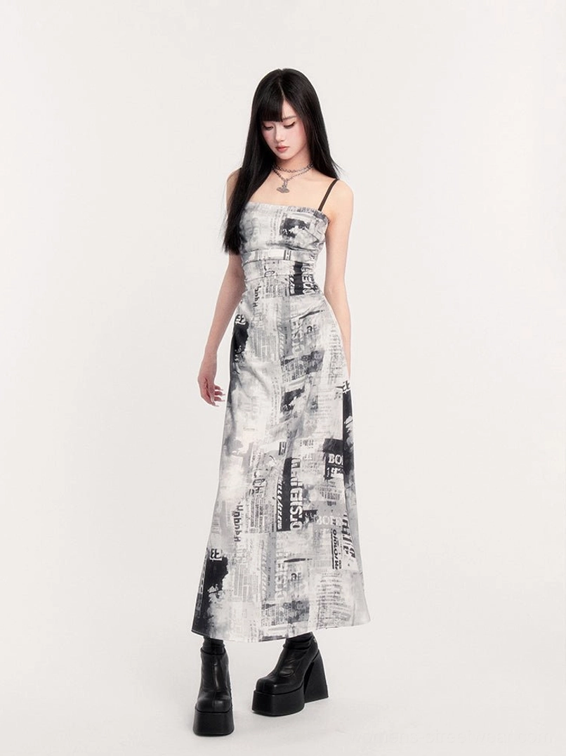 Side back view of white and black newspaper print maxi slip dress with thin black spaghetti straps