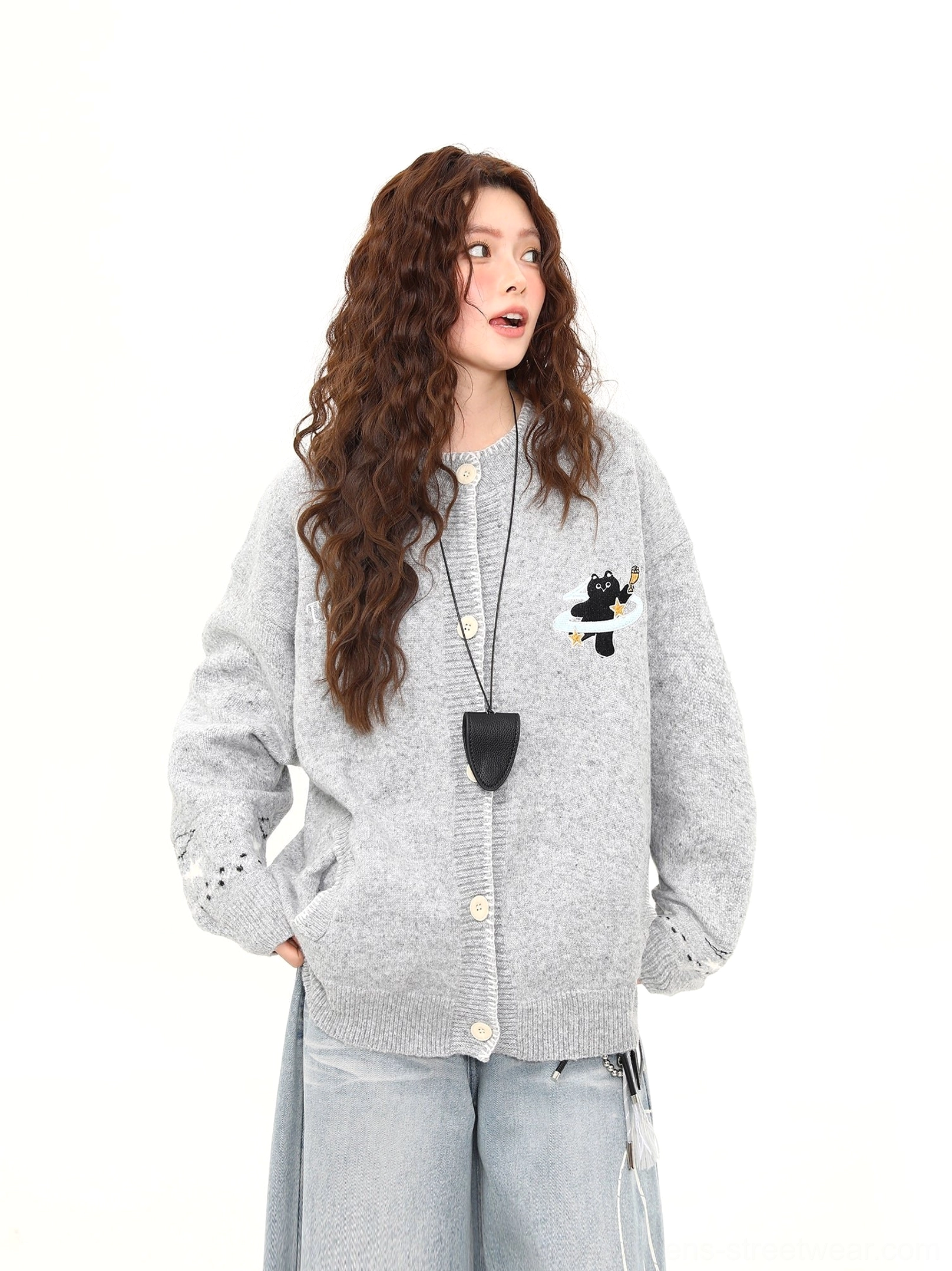 Angled front view of a Korean streetwear Moonlight Kitty cardigan featuring front buttons, ribbed edges, cat embroidery, and detailed sleeve cuffs