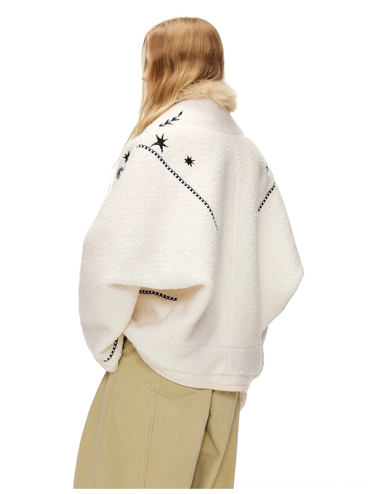 Back three quarter view of a moonlight white embroidered fleece jacket with faux fur neckline and black trim