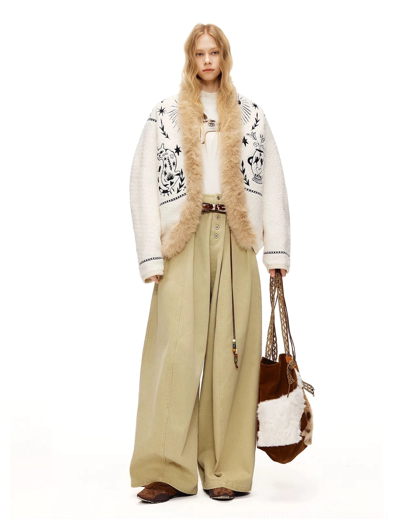Moonlight white embroidered fleece jacket styled with a white inner top, khaki trousers, and a two tone fur tote