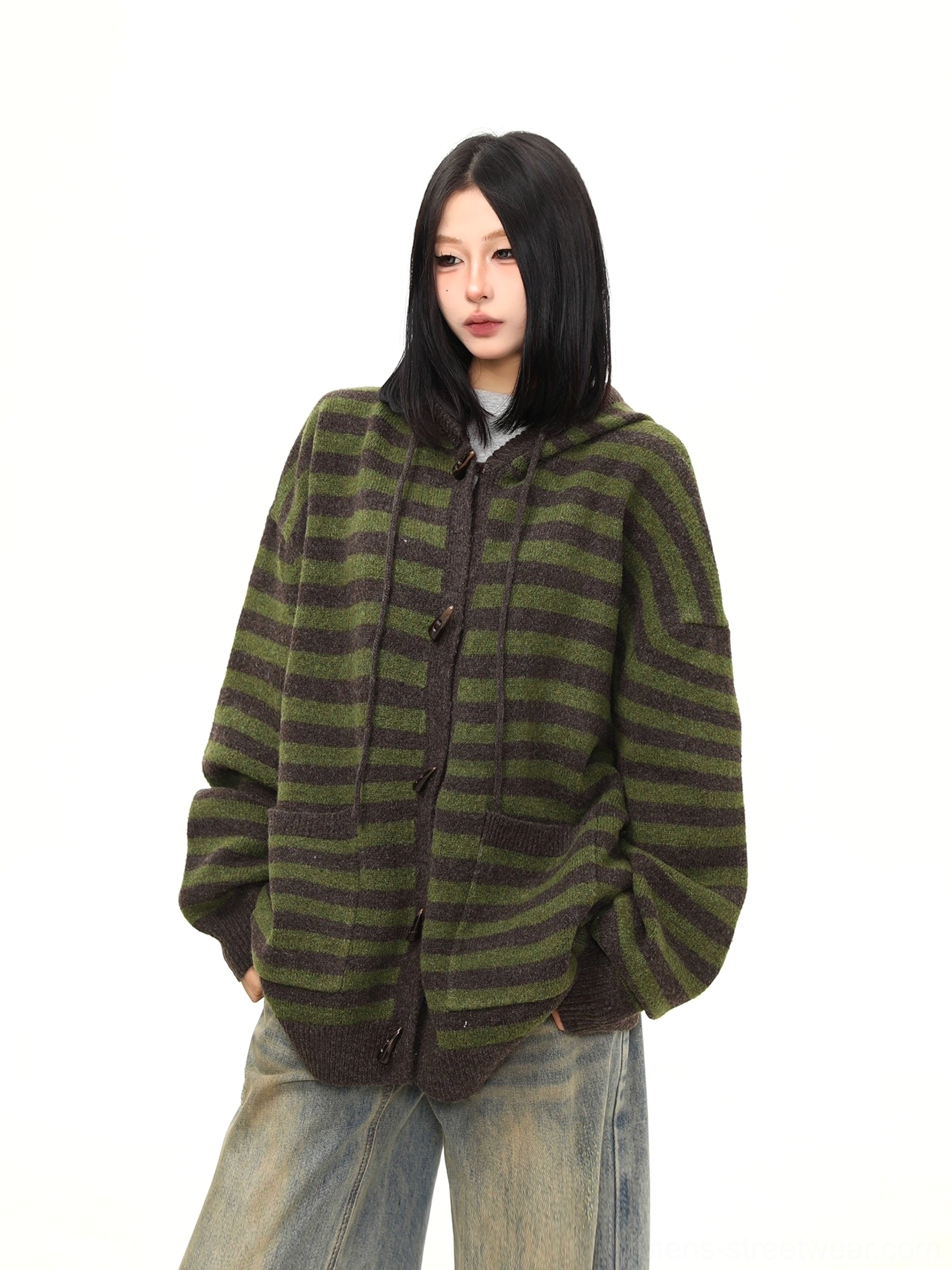 Three-quarter front view of a moss green striped hooded knit cardigan showing front patch pockets, drawstring hood, and relaxed fit
