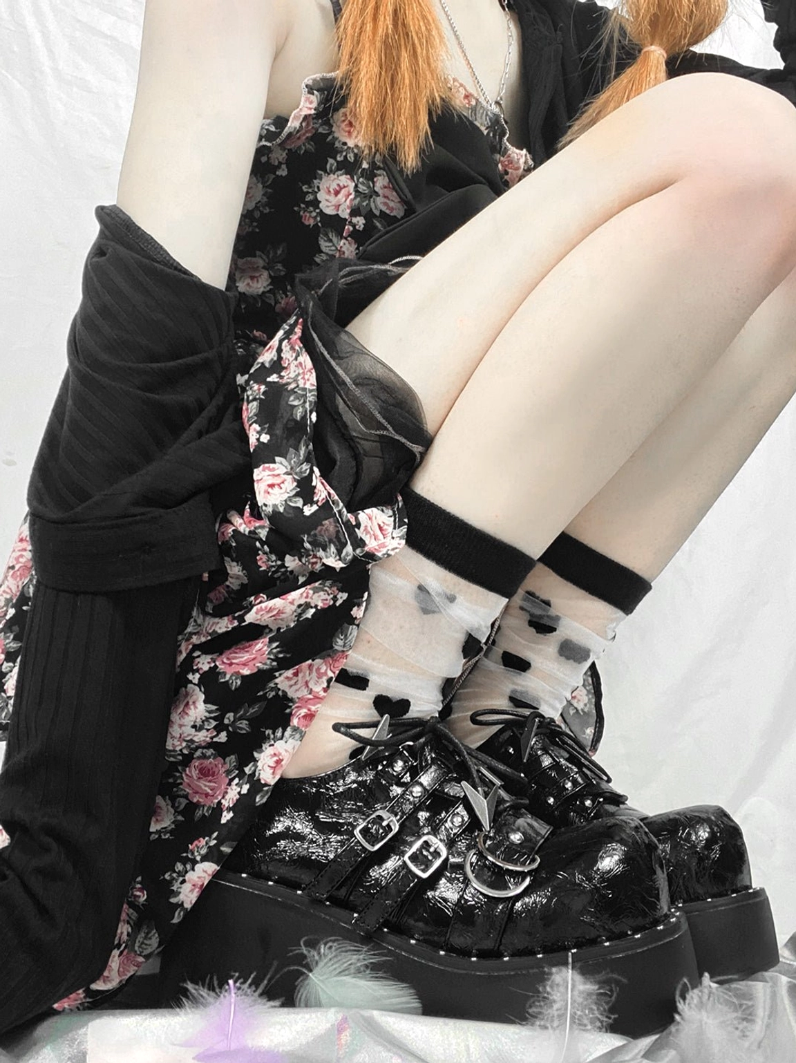 Black Gothic platform Mary Jane shoes worn with a floral dress and printed sheer socks in an alternative streetwear outfit