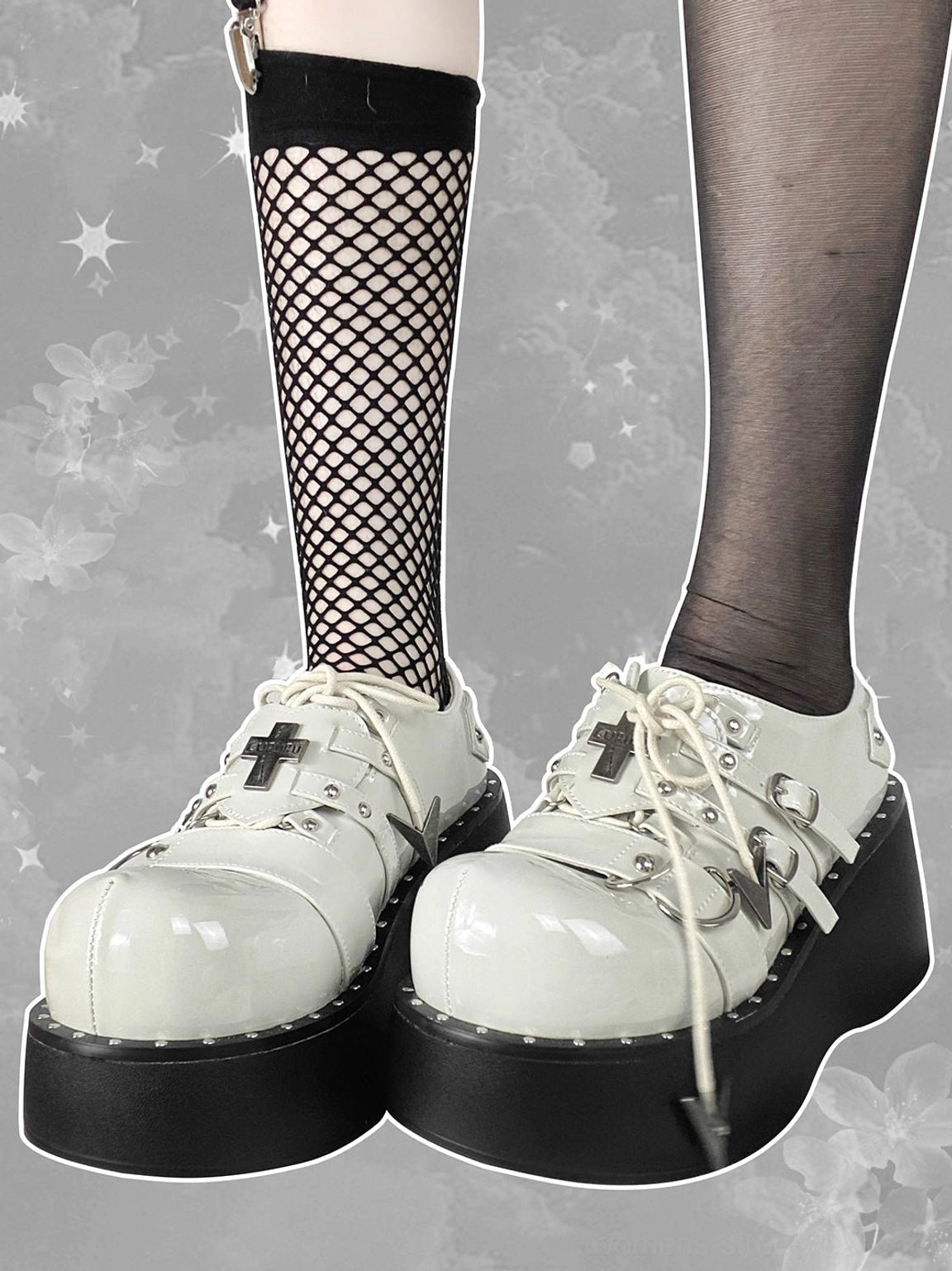 White patent multi-buckle Gothic platform Mary Jane shoes worn with fishnet stockings and ankle strap accessories