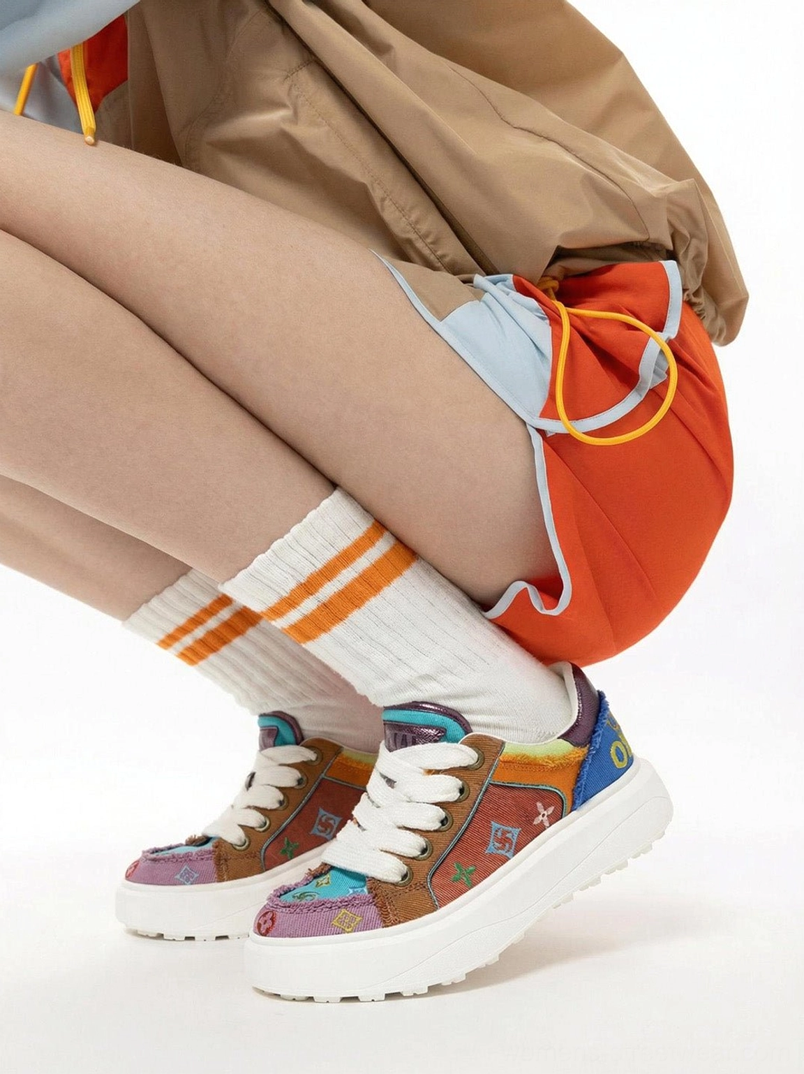 Overhead close-up of multicolor embossed platform skate sneakers showing colorful textured upper and chunky layered outsole