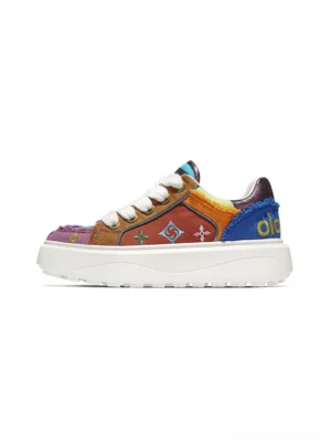 Side view of multicolor embossed platform skate sneakers with blue orange purple panels frayed trim and thick white streetwear sole