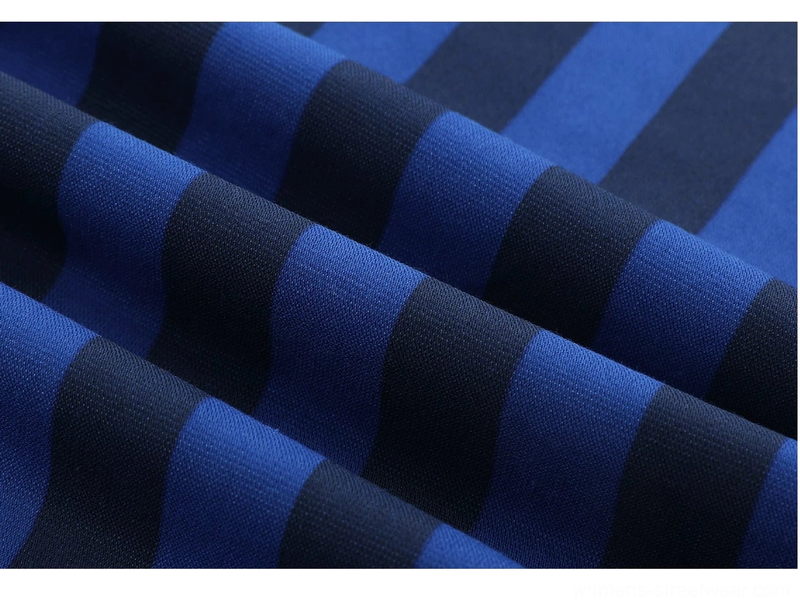 Close-up of deep blue and navy horizontal striped cotton blend jersey fabric texture
