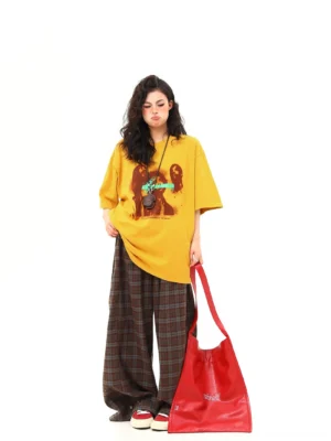 Mustard oversized graphic streetwear tee three-quarter back view showing relaxed drop-shoulder fit and solid yellow back