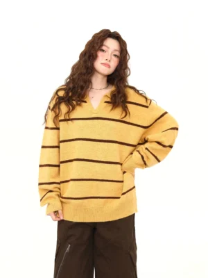 Front view of mustard yellow and brown striped oversized knit polo sweater with open V-neck collar and ribbed hem