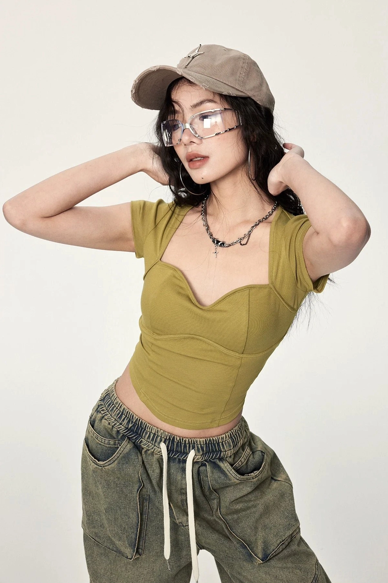 Mustard yellow fitted crop top with sweetheart neckline, ribbed fabric, short cap sleeves, and twisted open back streetwear design