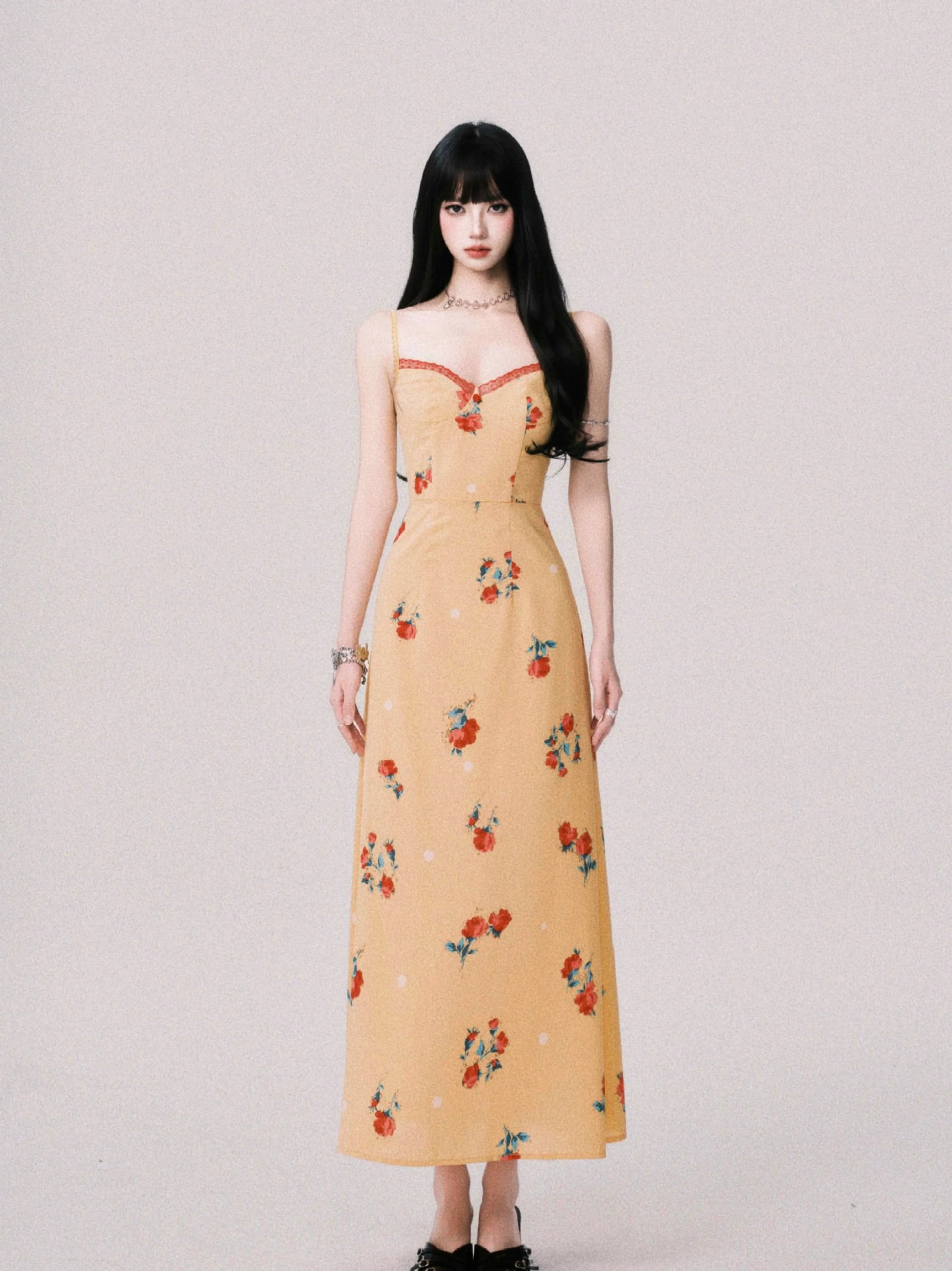 Mustard yellow floral maxi dress featuring a red trimmed sweetheart neckline fitted bodice and elegant floor length skirt