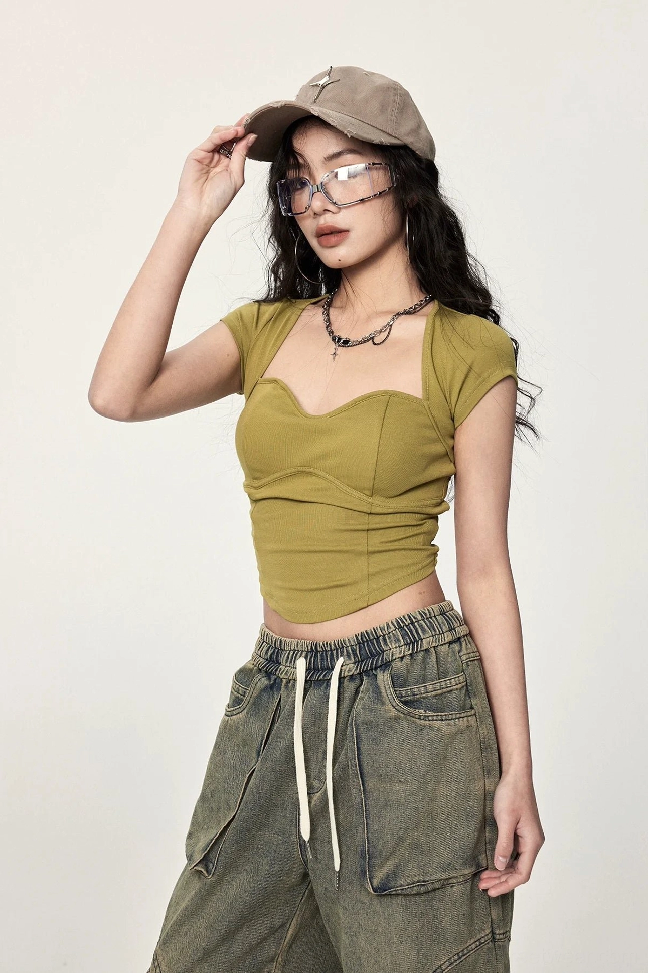 Mustard yellow Korean style cropped top with ribbed knit texture, sweetheart neckline, curved bust seams, and fitted streetwear shape