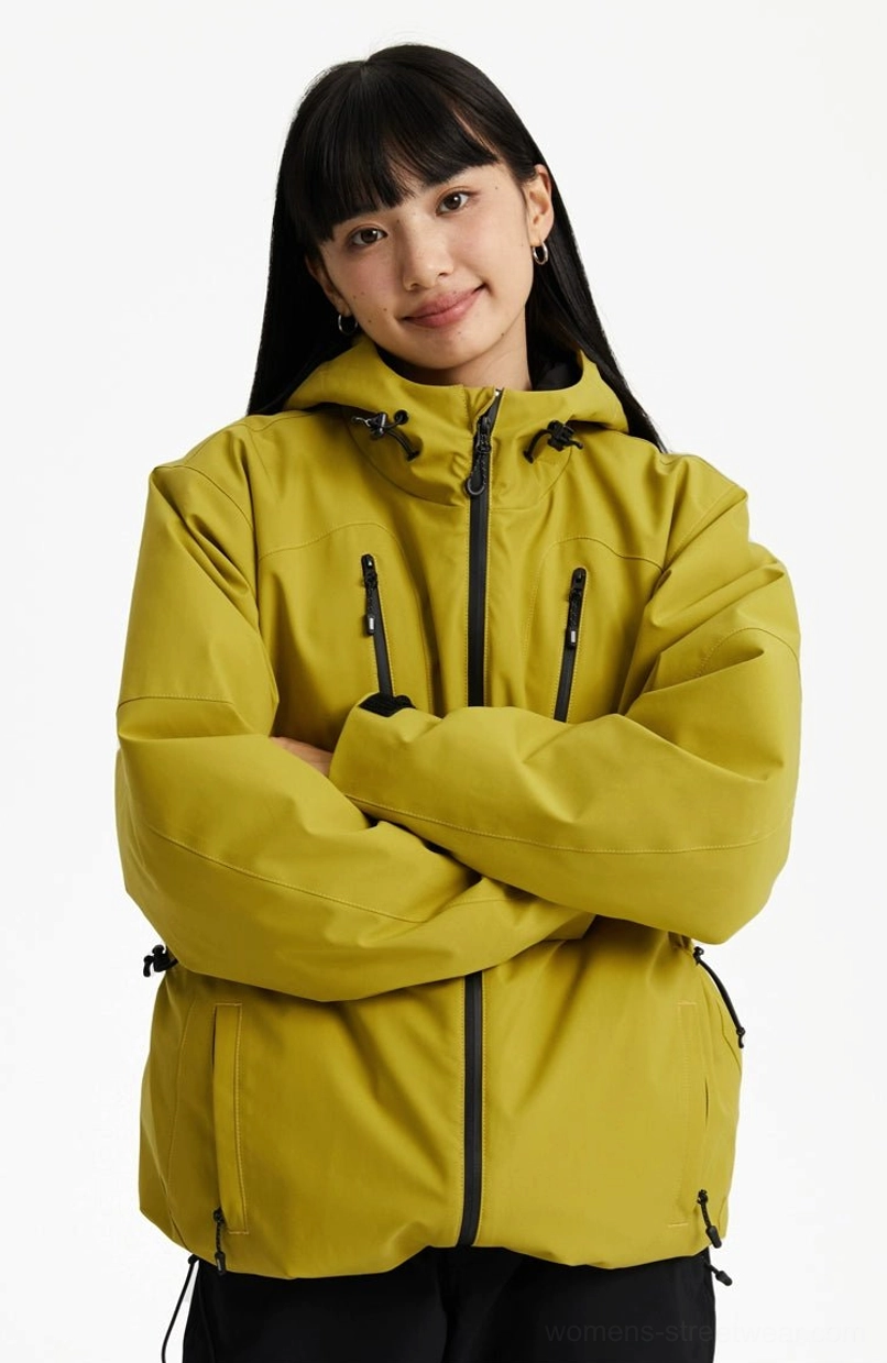 Mustard yellow outdoor padded hooded jacket in a relaxed fit with front zipper, chest pockets, and adjustable hood