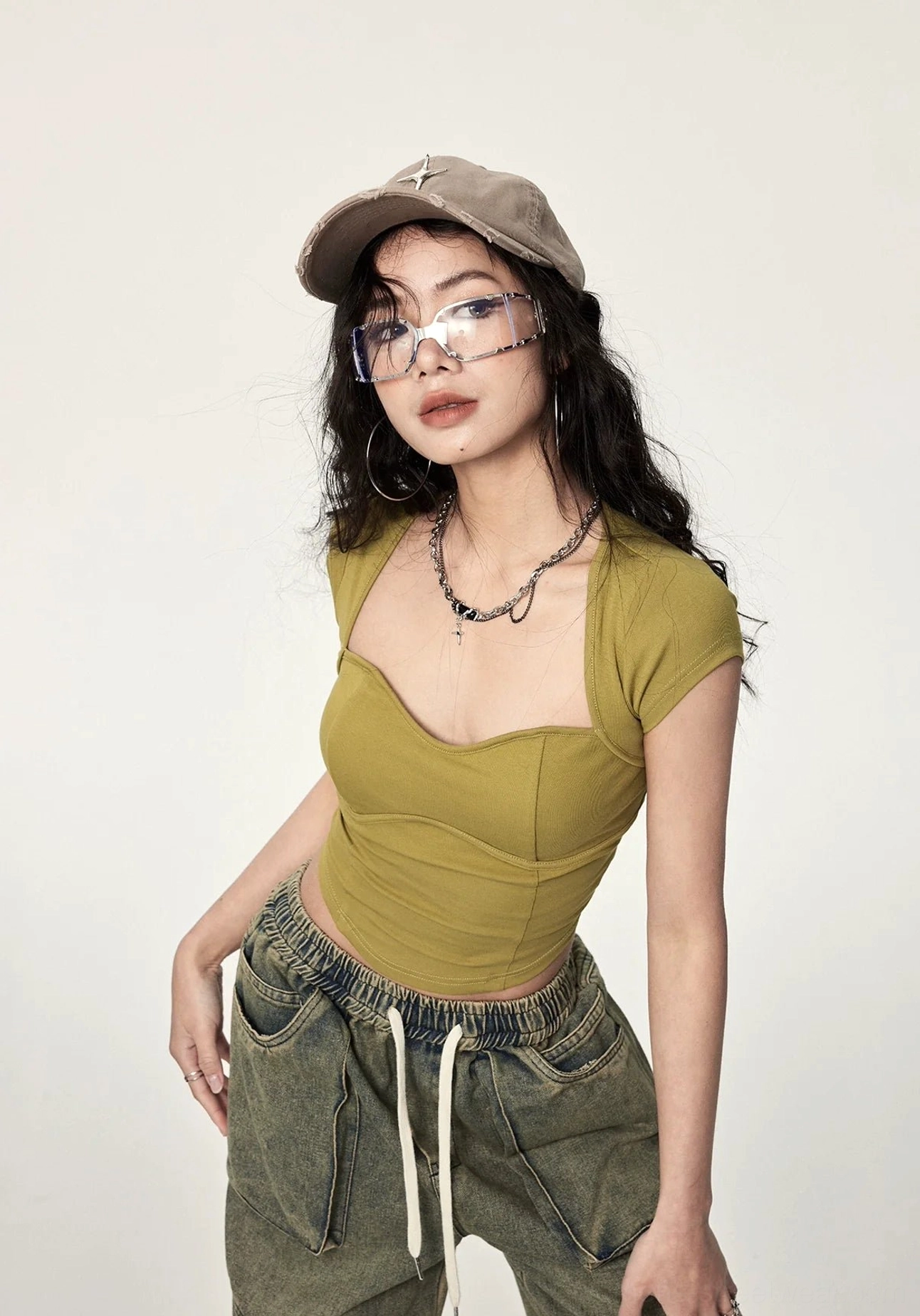Mustard yellow ribbed cropped streetwear top featuring a sweetheart neckline, fitted cut, short sleeves, and statement open back