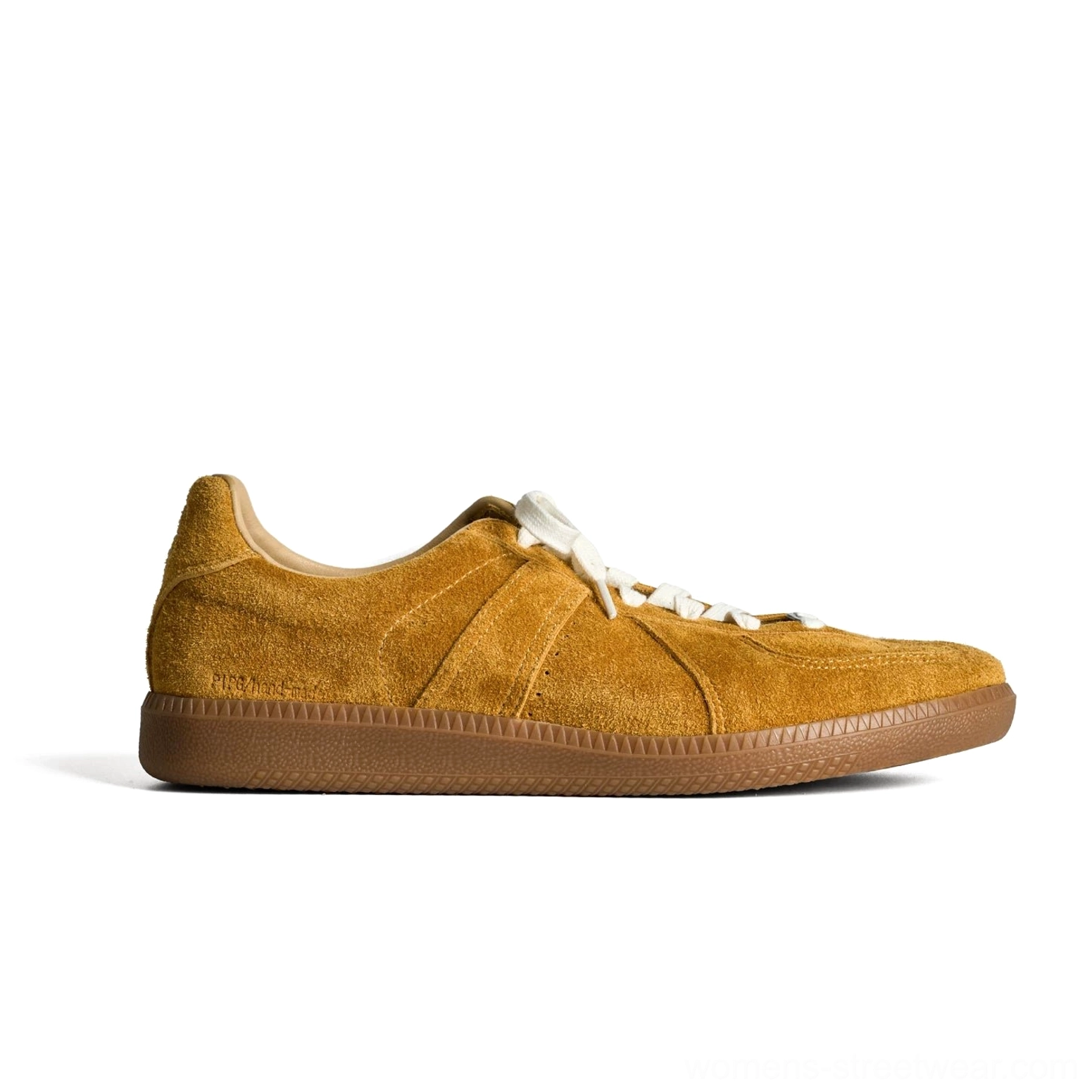 Mustard yellow suede German army style heritage sneakers with clean white laces and gum rubber sole on a white studio background