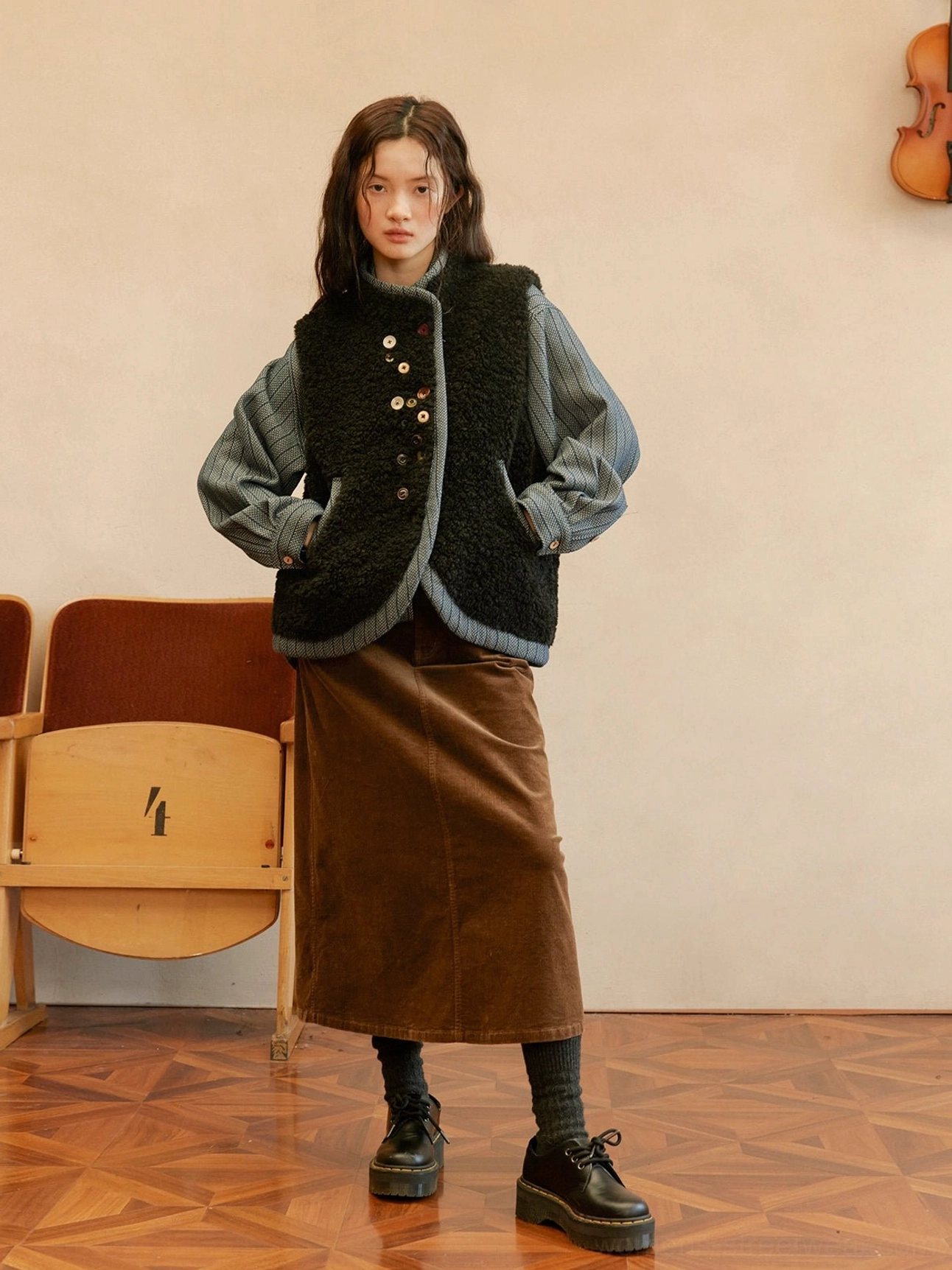 Mysterious black reversible sherpa and denim vest with relaxed streetwear silhouette and contrast button-front details