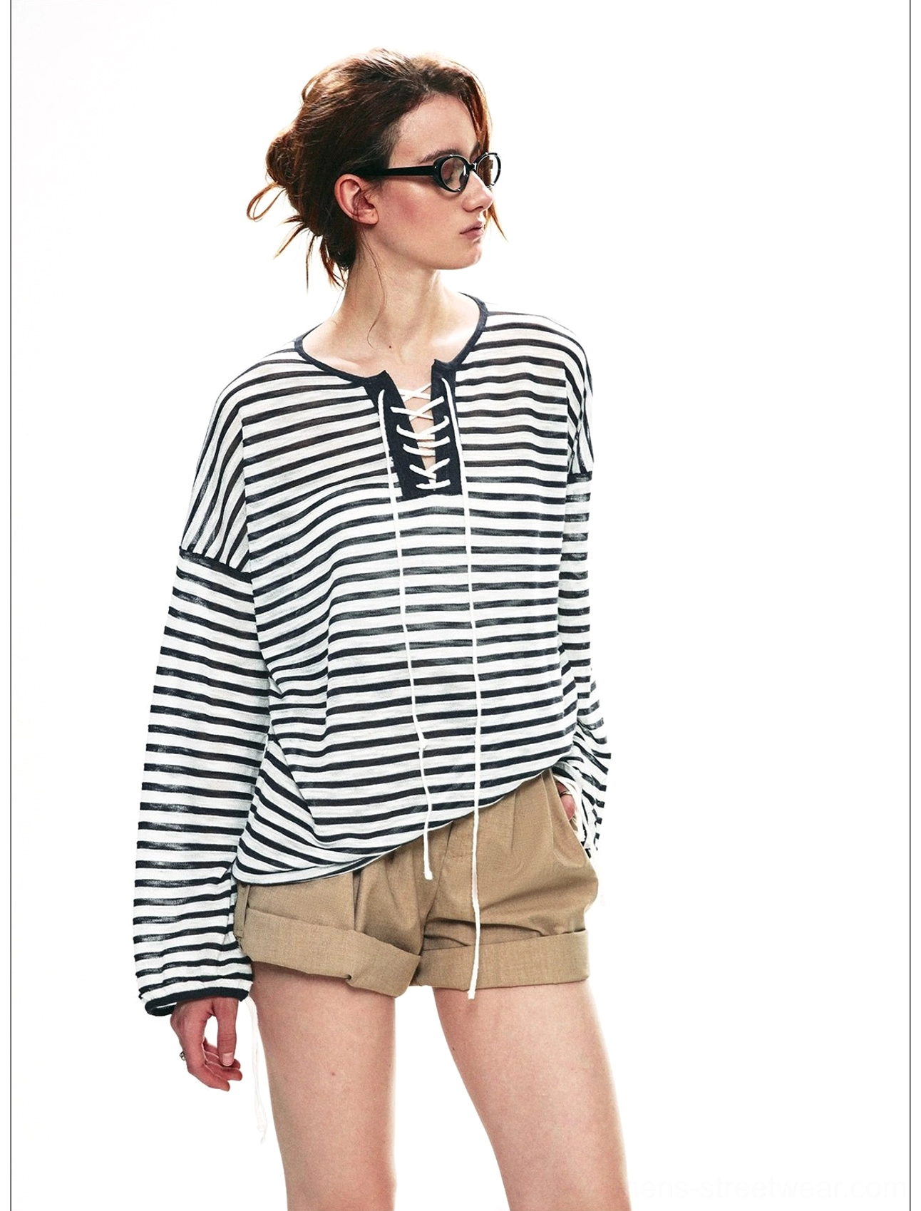 Close-up of dark gray and white striped lace-up neckline on relaxed nautical long sleeve top